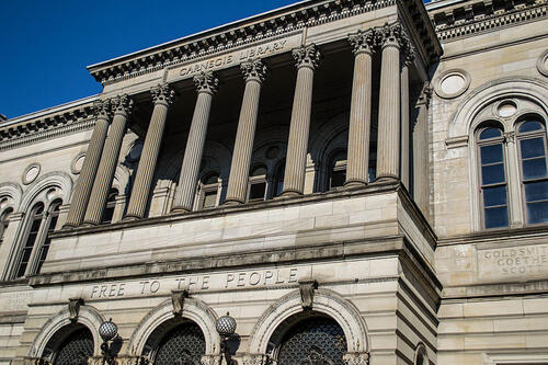 Picture of the front of the Carnegie Public Library in Pittsburgh with "Free to the People" over main entrance.