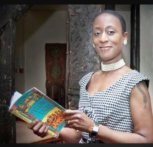 Picture of Patience Agbabi holding her book, Telling Tales.