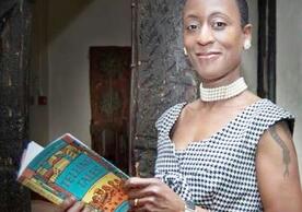 Picture of Patience Agbabi holding her book, Telling Tales.